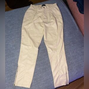 - Faux leather cream colored pants. Zippered ankles Size medium